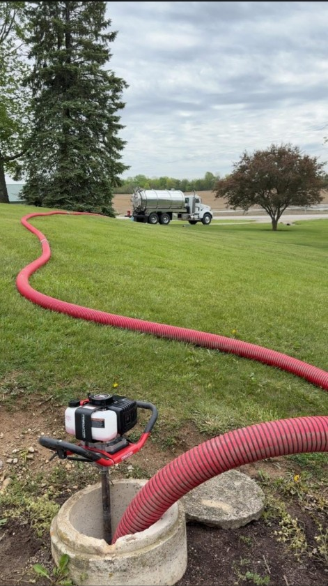 Septic service hose running across a yard
